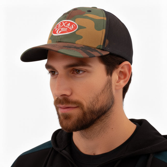 Texas Gear Emblem. Adorn the FlexFit YP Classic Retro “CAMO” Trucker Hat